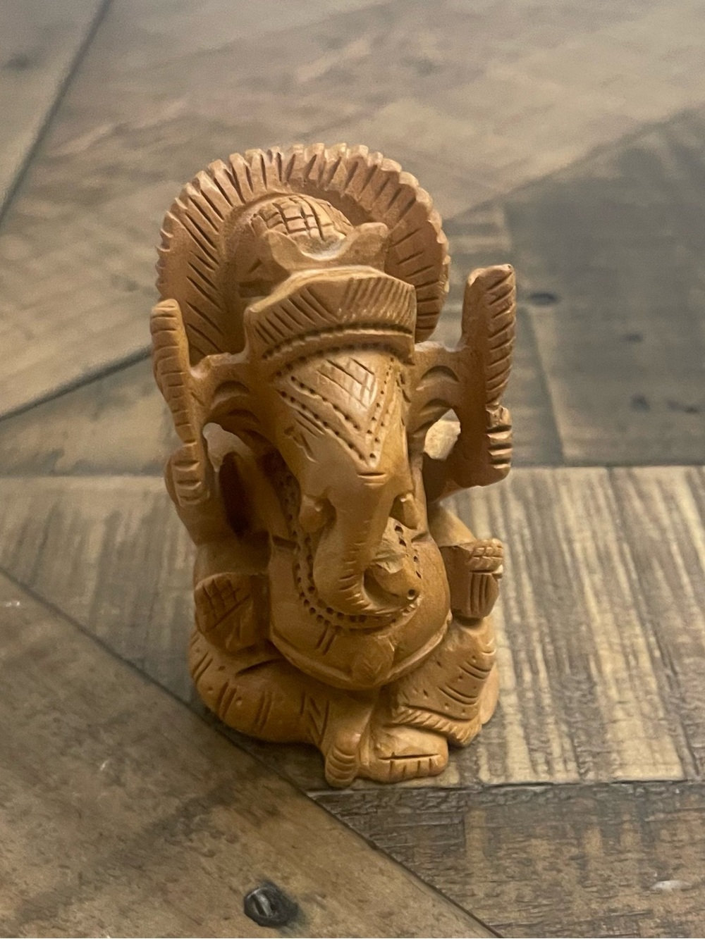 handcrafted wooden Ganesha idol, often referred to as a Ganesh murti